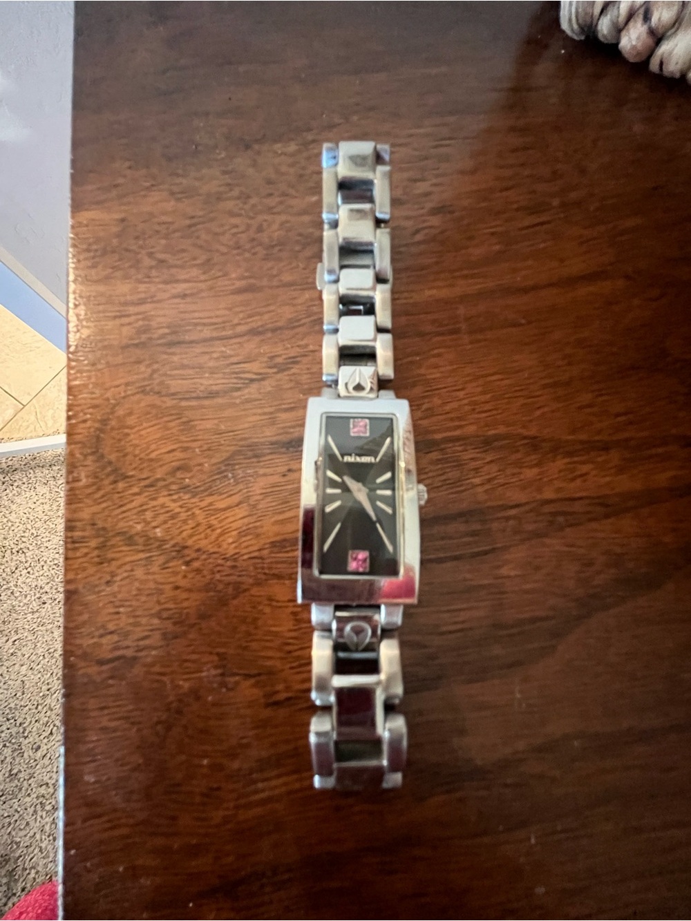 NIxon Stainless Steel Bracelet Watch with Black Dial and Pink Accents.